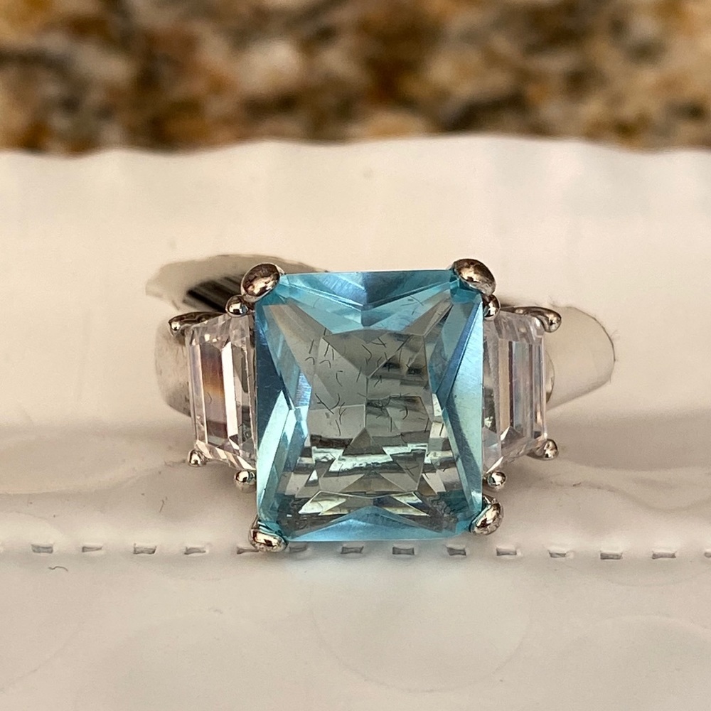 Aquamarine like emerald ring with with side stones